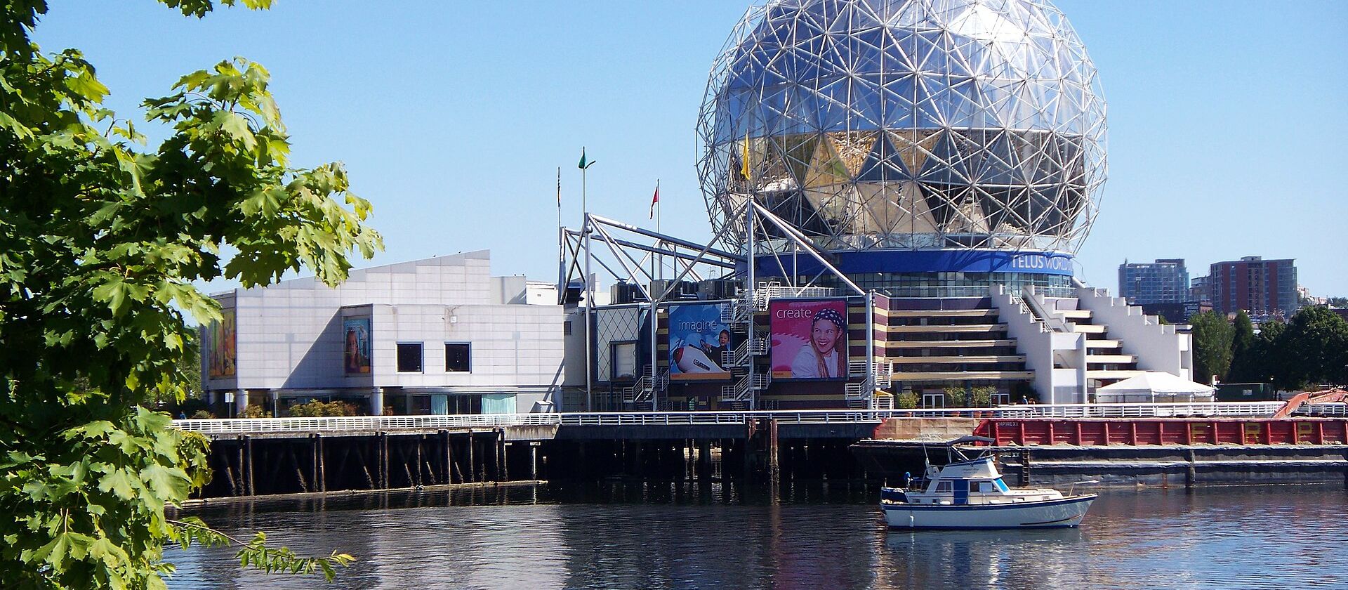 Science World reflected in calm False Creek water at dusk